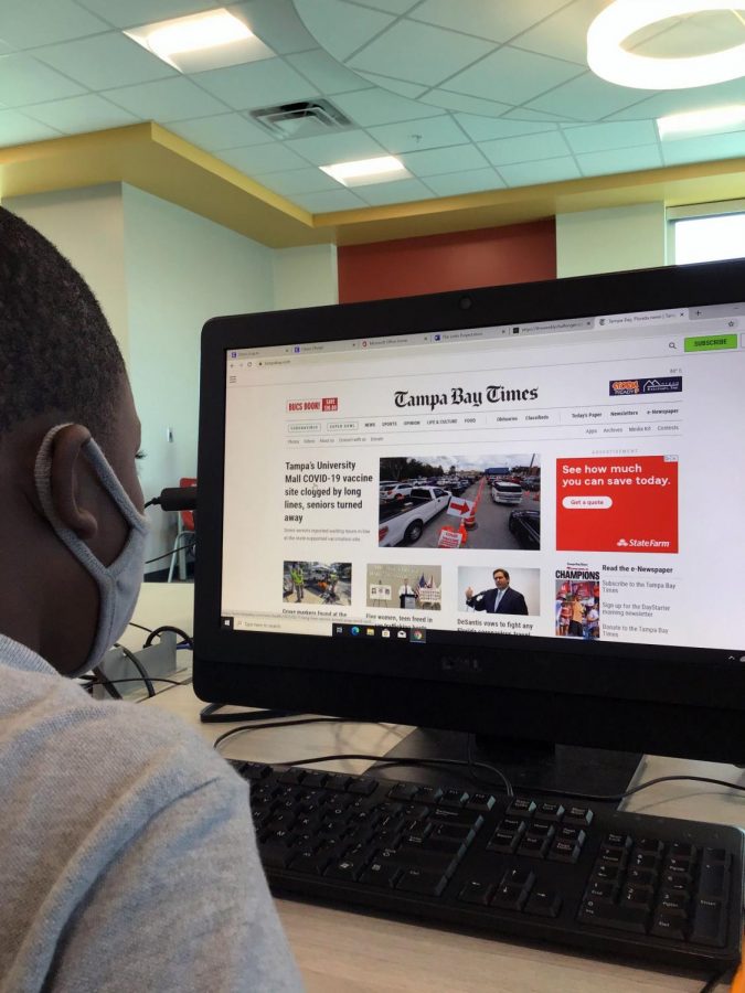 Fourth grade scholar Travis Flowers accesses the Tampa Bay Times online to conduct research for a story.