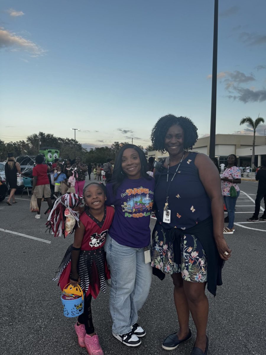 Dr. Harris with a first grader and Ms. Garvey